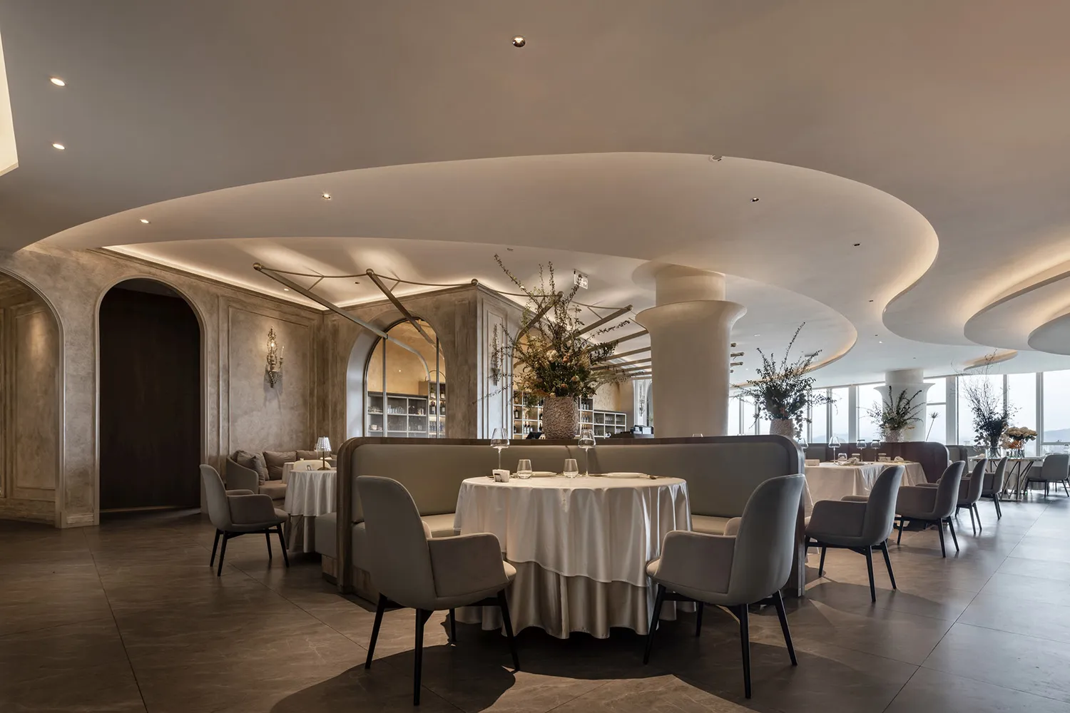 A modern elegant dining room with soft lighting and contemporary furniture.