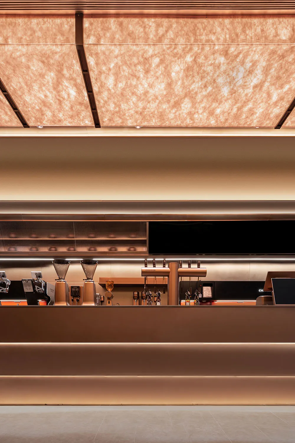 Interior view of a modern coffee shop bar counter with a metallic design