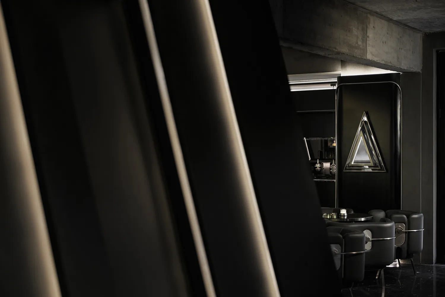 Industrial-style bar interior with metallic black materials and minimalist design