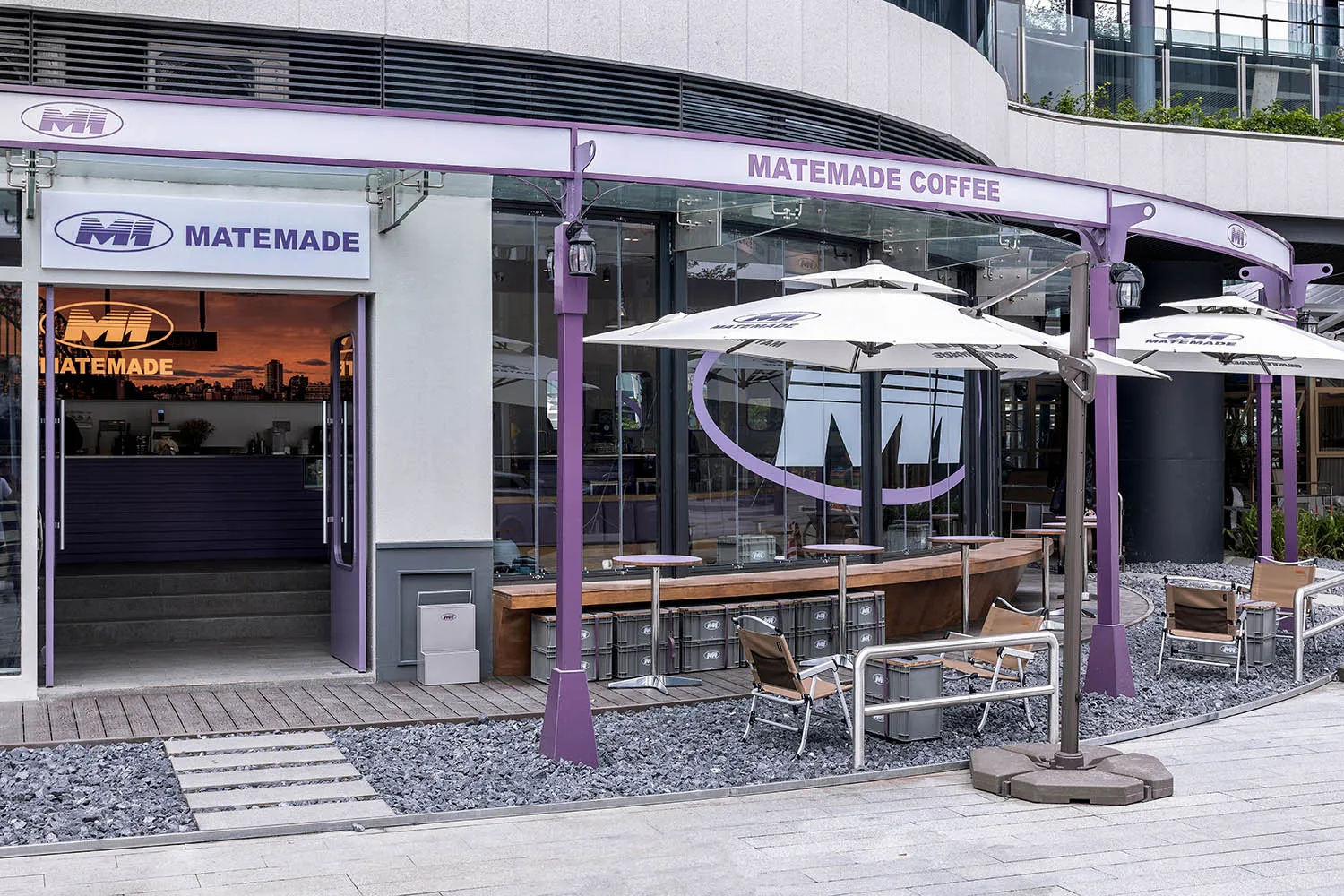 Modern coffee shop exterior with concrete and glass materials.