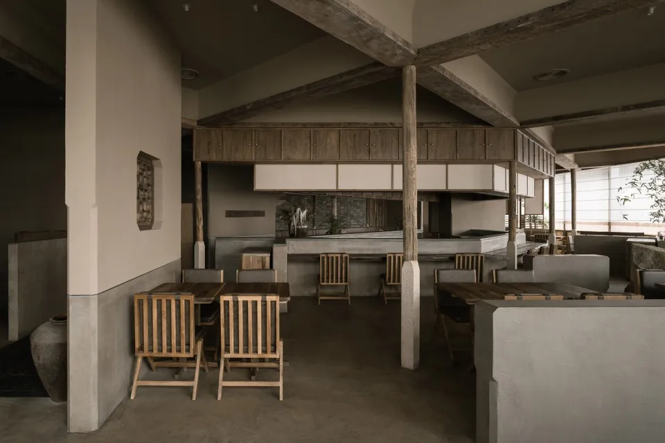 Industrial-themed restaurant interior with concrete finishes and minimalist design.