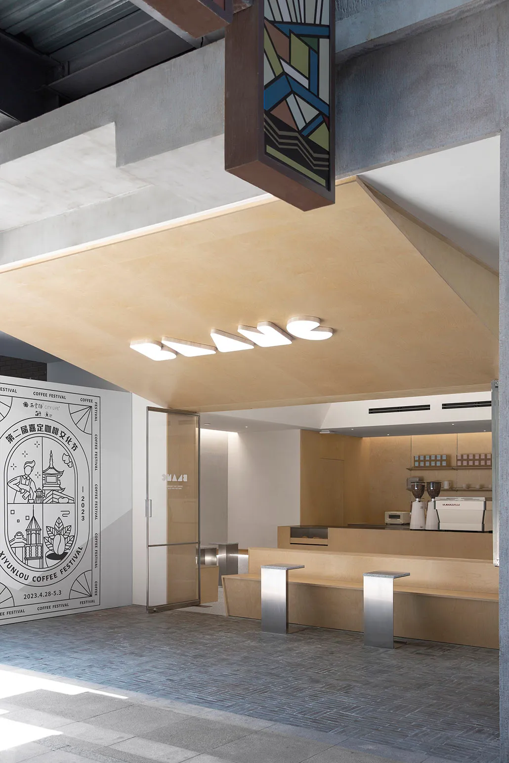 Modern coffee shop with an industrial-style counter made of wood.