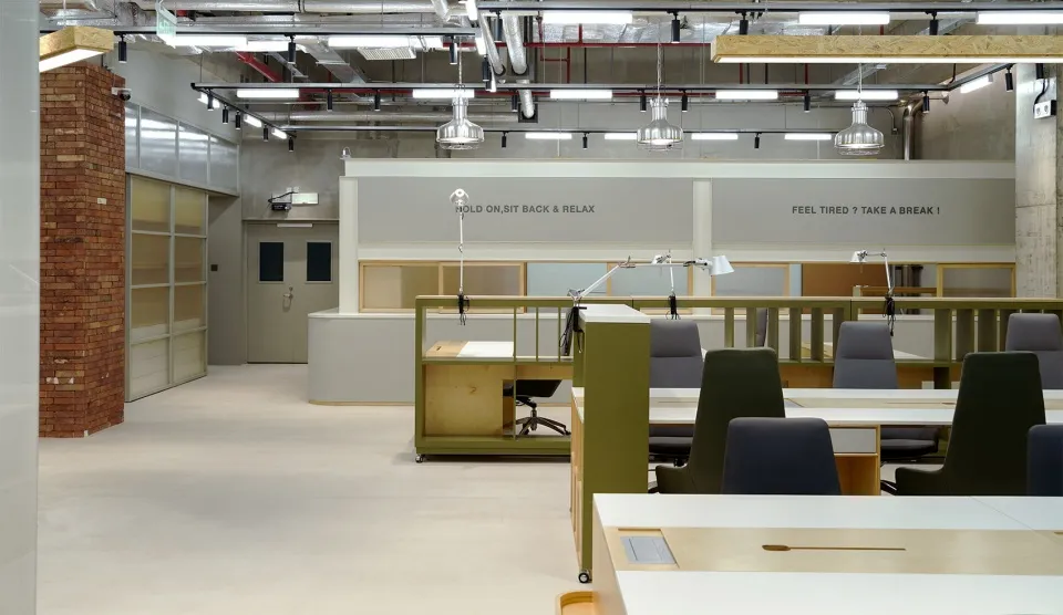 Modern office space with concrete walls and minimalist furniture.