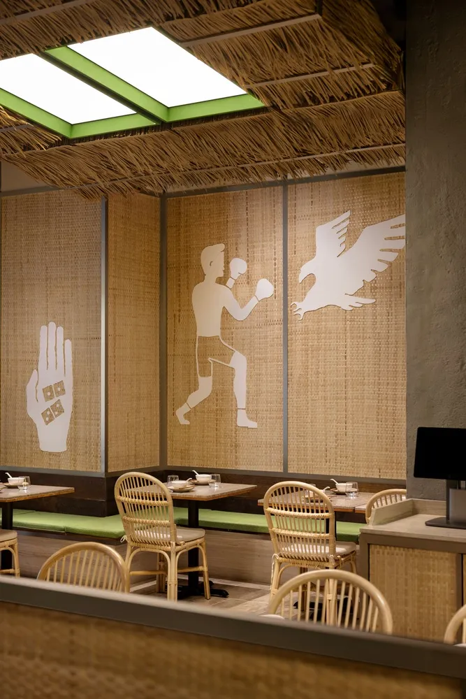 Casual dining room with bamboo decor, featuring a boxer silhouette and an eagle illustration.