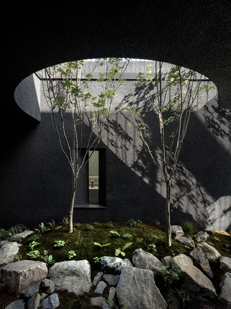 A minimalist interior design featuring concrete walls and a moss-covered floor with a small window and unique architectural e