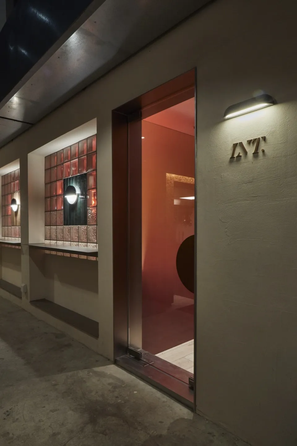 Modern building exterior featuring concrete and red materials