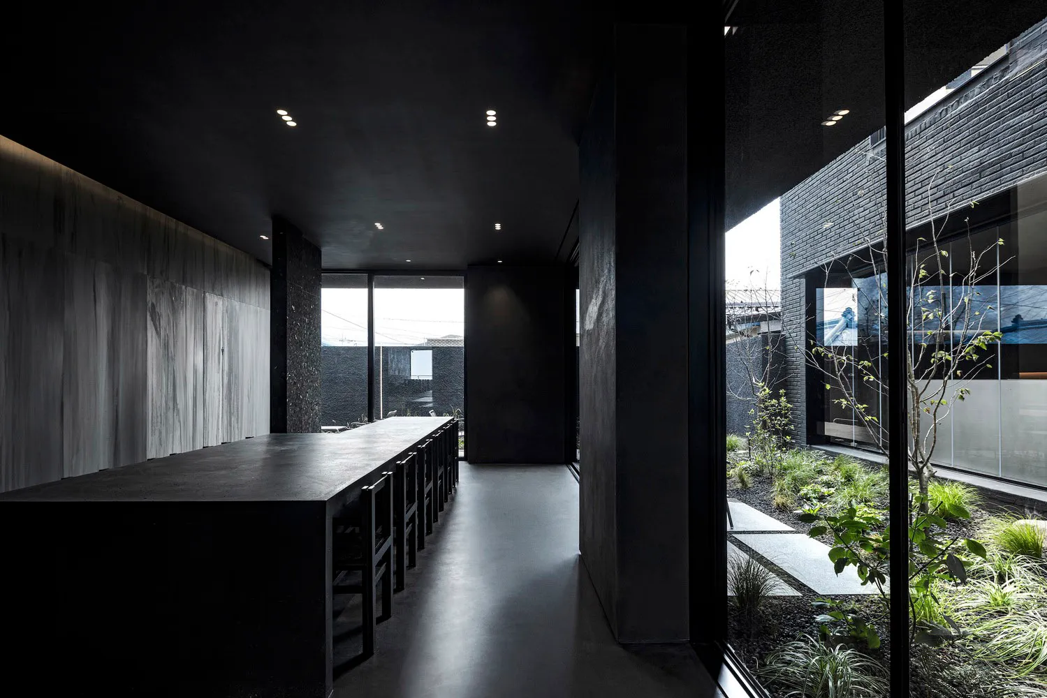 Interior of a modern, minimalist concrete house with a spacious open-plan living space.