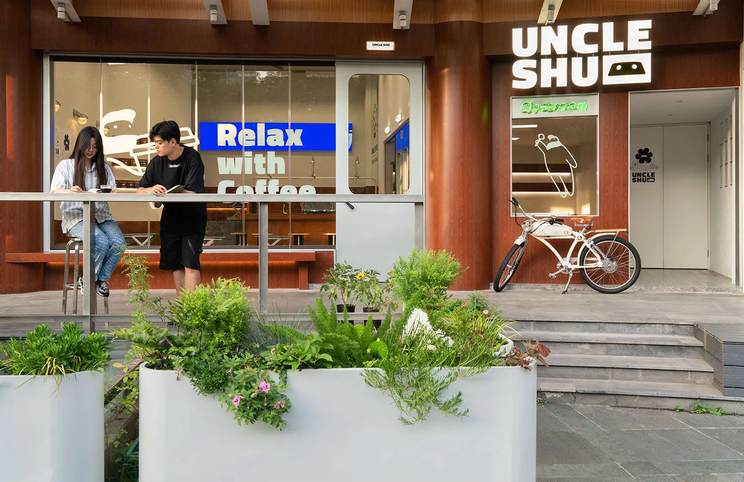 Coffee shop interior with wooden walls, glass partitions, and plants