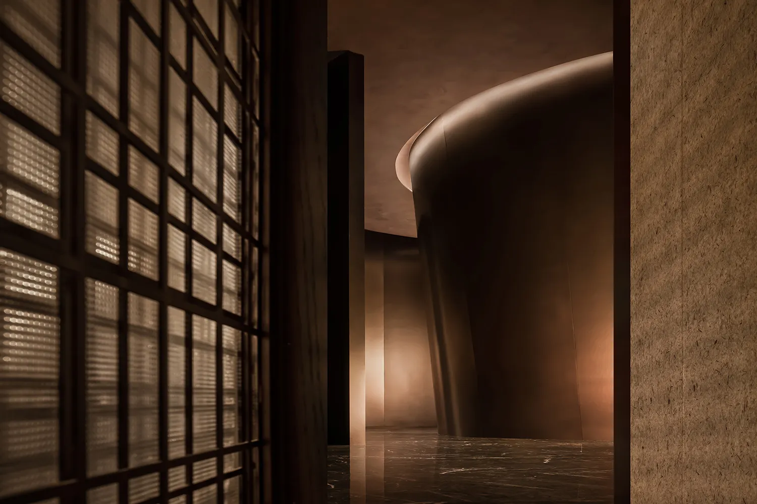 A modern glass lobby with a curved wall and light reflecting off the glass.