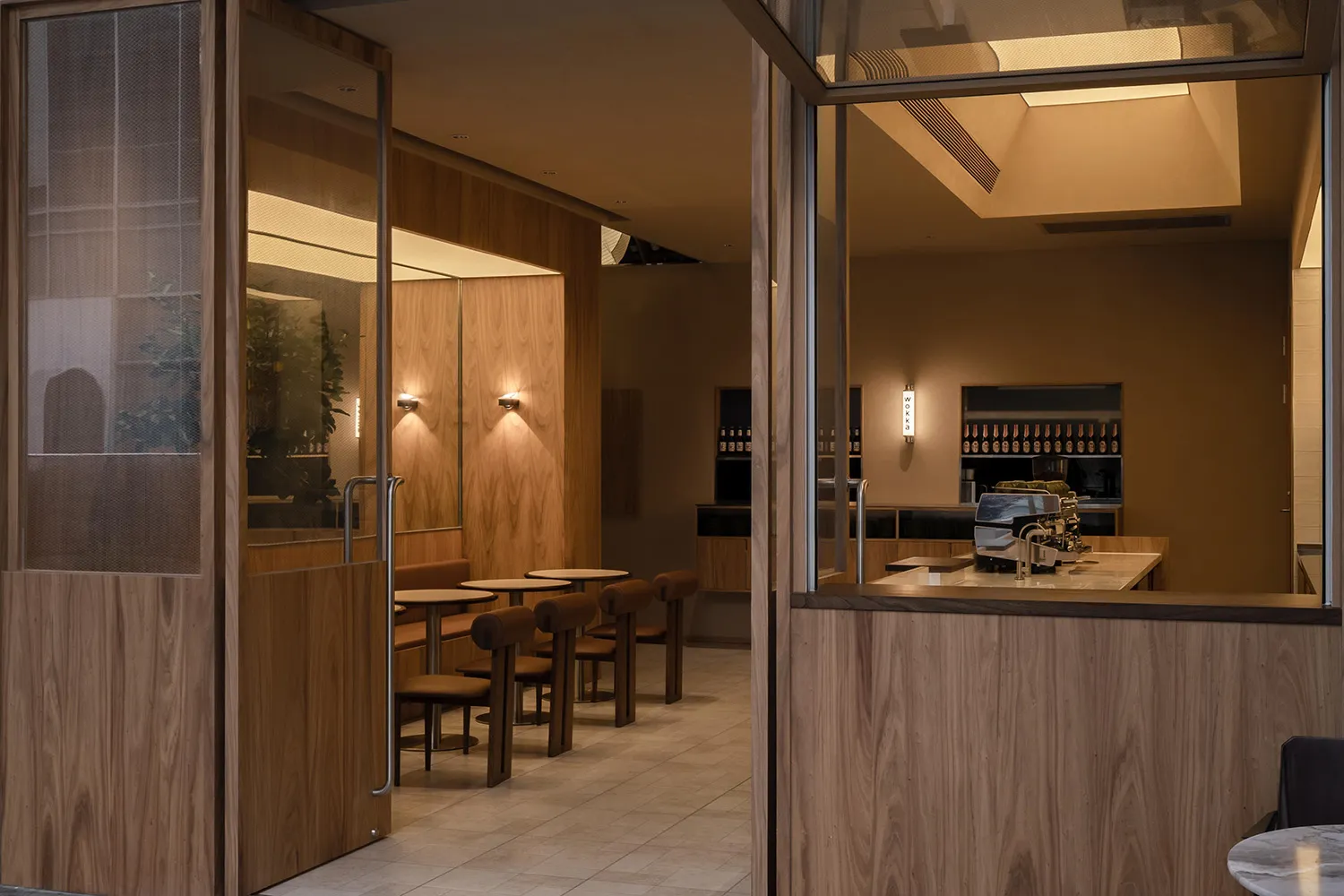 Interior of a modern restaurant with wooden accents and seating arrangements.