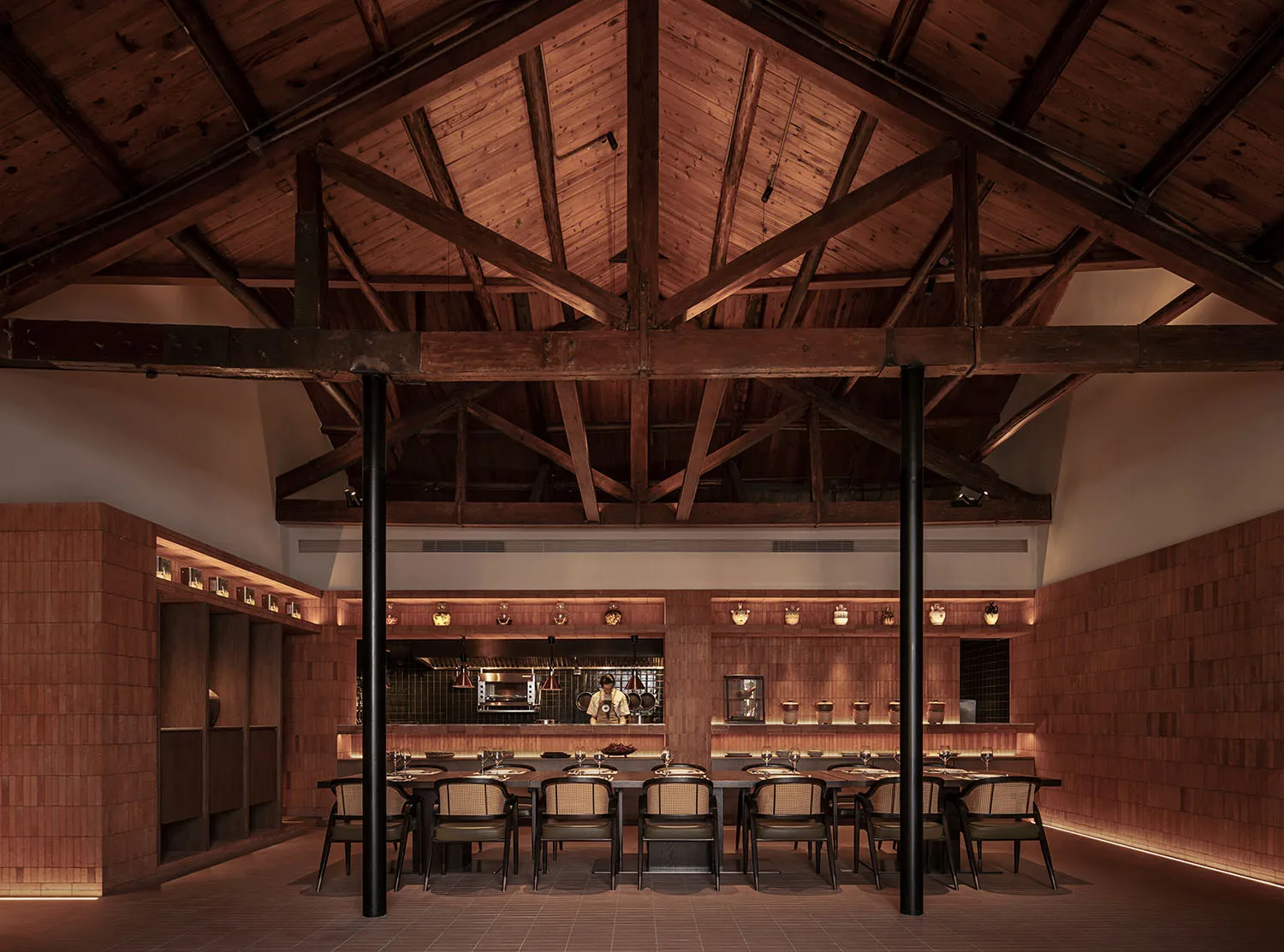 Industrial restaurant interior with wooden beams and tables.