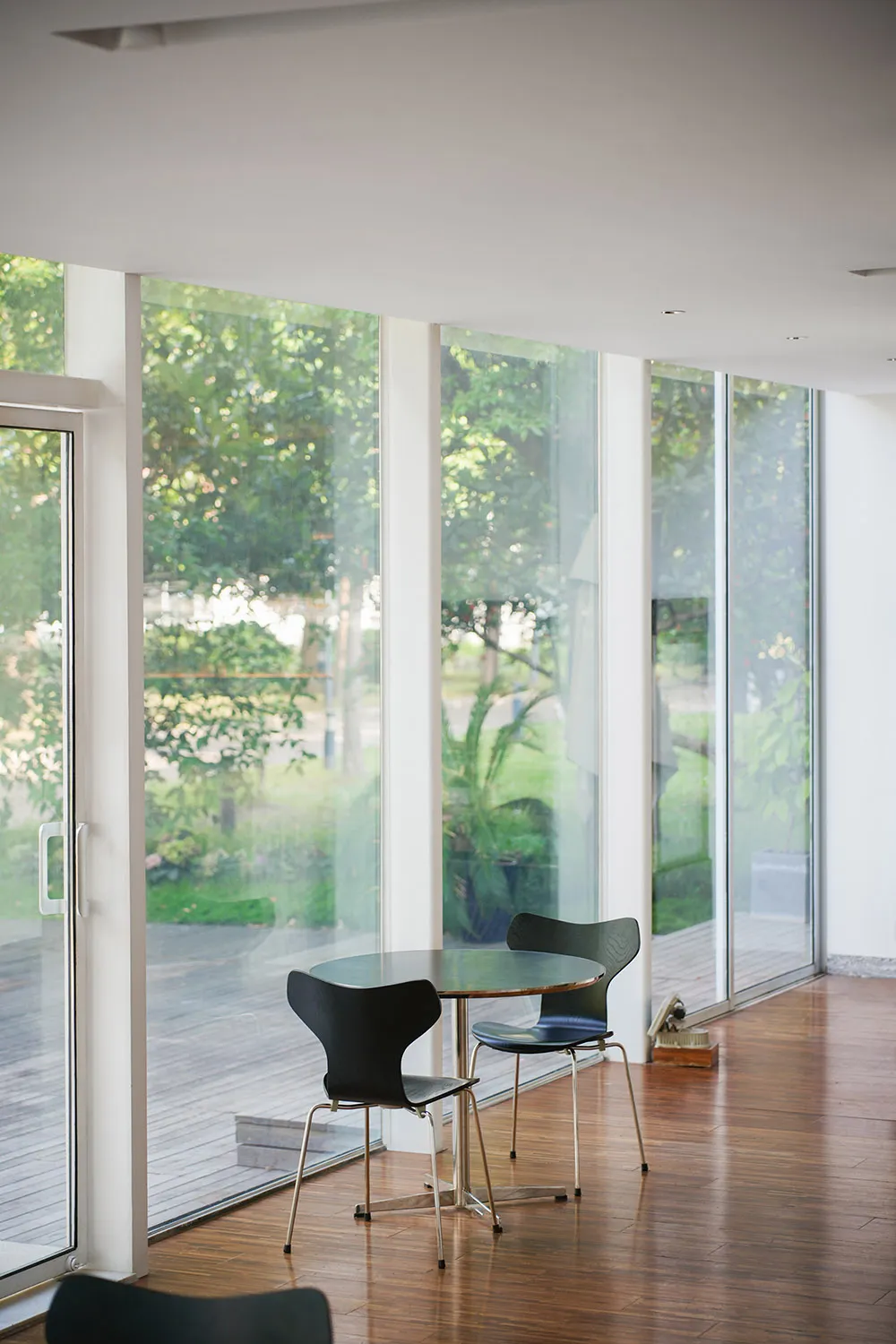A modern coffee shop with a glass front, featuring a welcoming interior space.