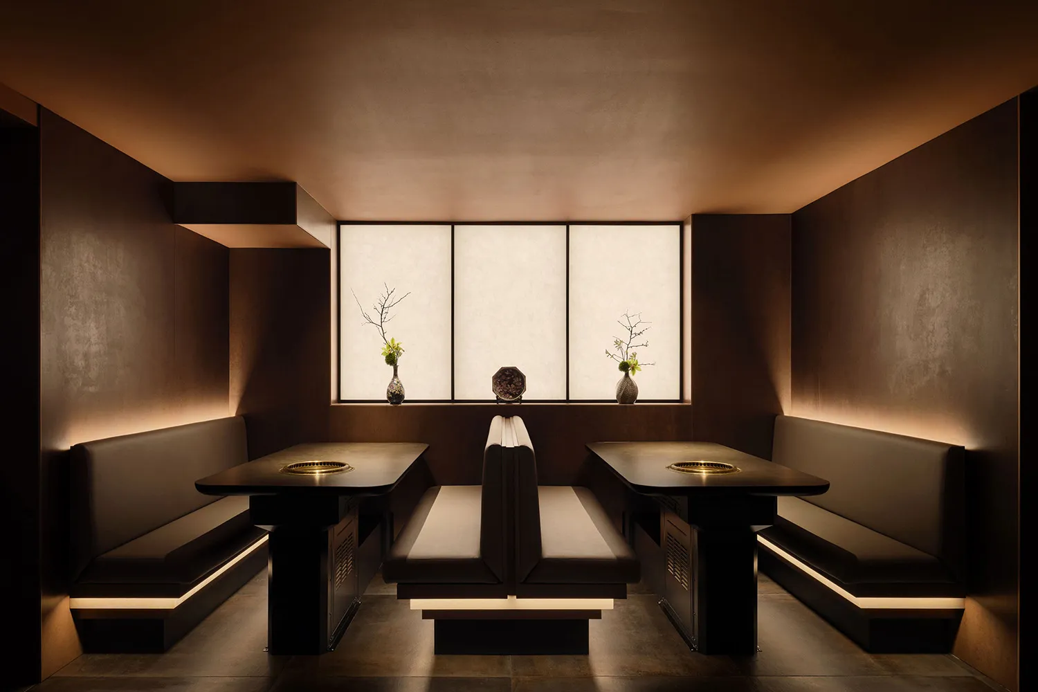 Cordovan leather restaurant interior with traditional Japanese seating and modern fixtures.