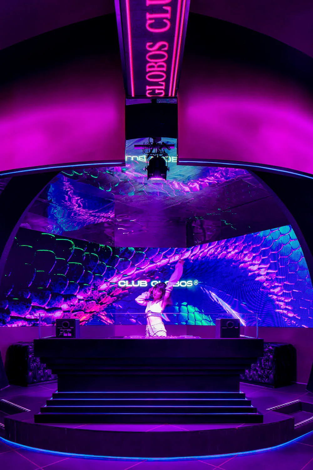A vibrant nightclub venue featuring a digital light installation with a lizard skin pattern and the text 'CLUB GLOBOS'.