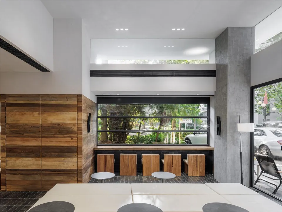 Modern cafe bar with wood and concrete materials.