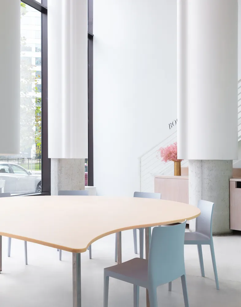 A modern minimalist cafe interior with a neutral color palette and clean lines.