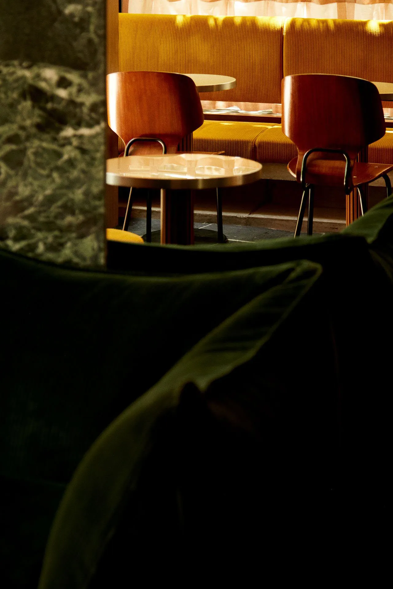 A cozy cafe interior with wooden furniture and seating.