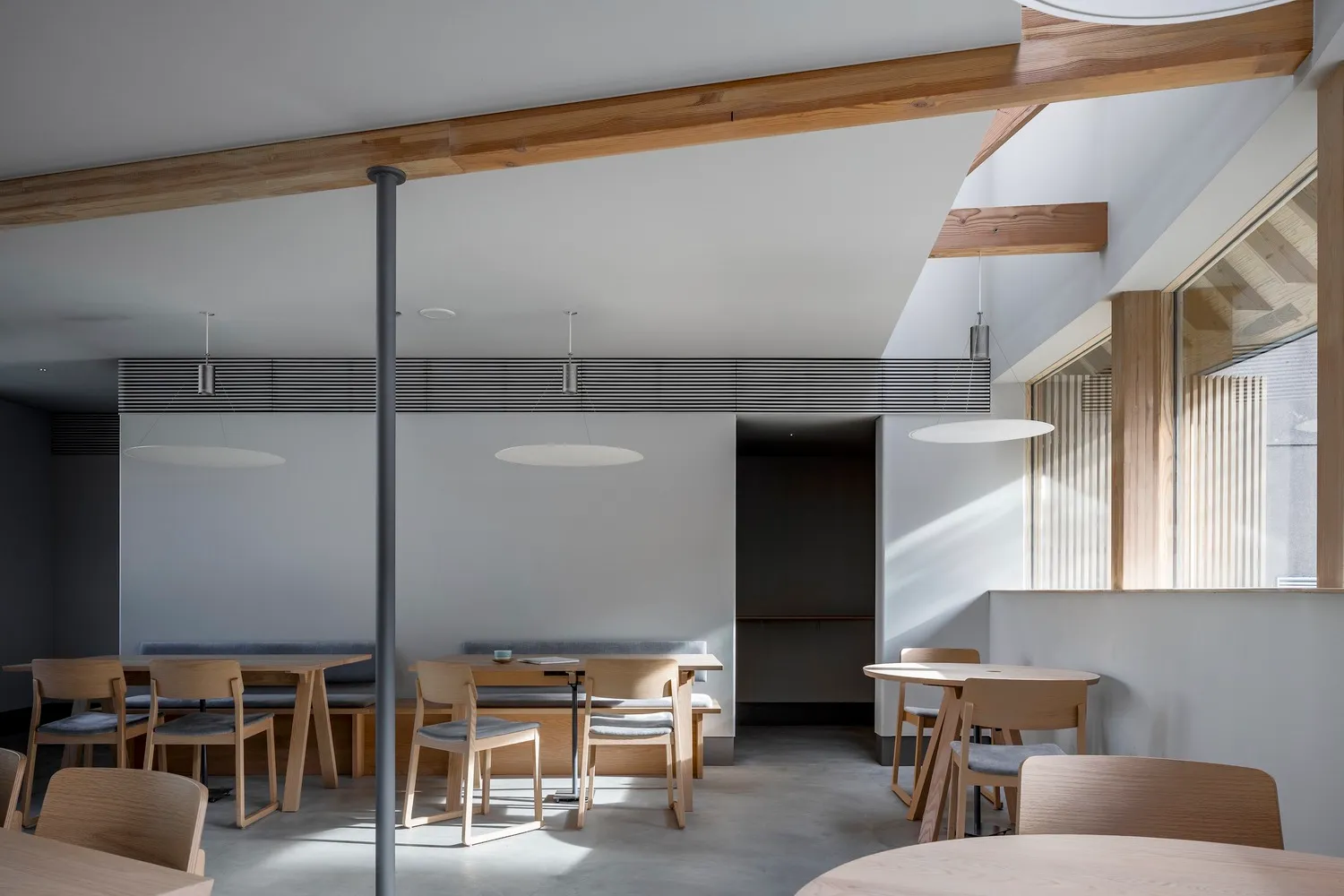 Industrial-style restaurant interior with wooden furniture and concrete flooring