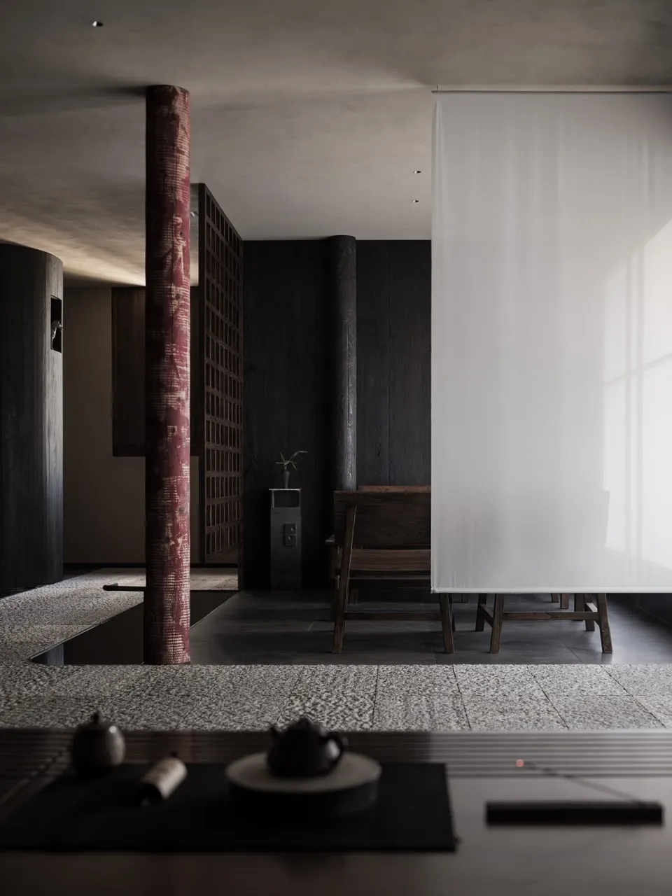 A minimalist residential space featuring a wooden cabinet and stone floor.