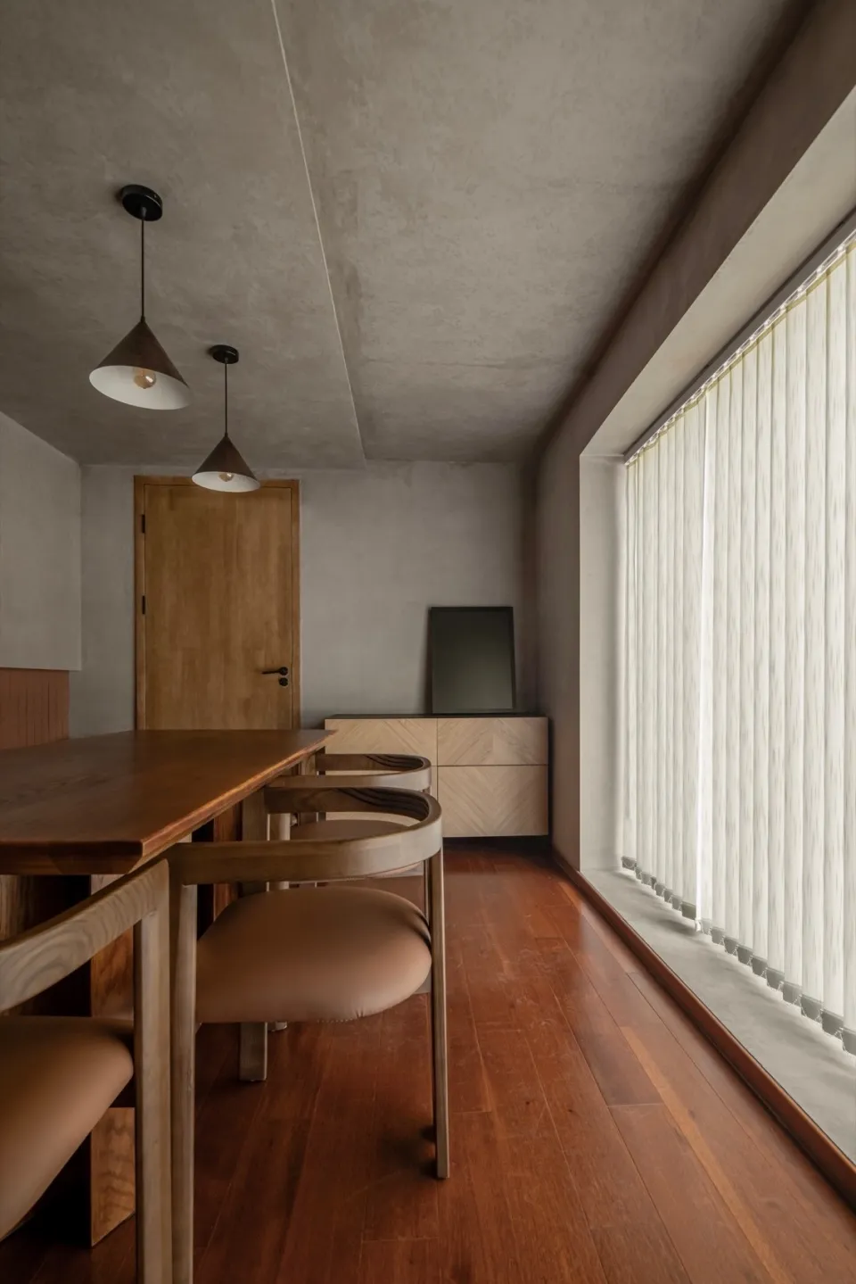 Modern dining room featuring wooden furniture and flooring.