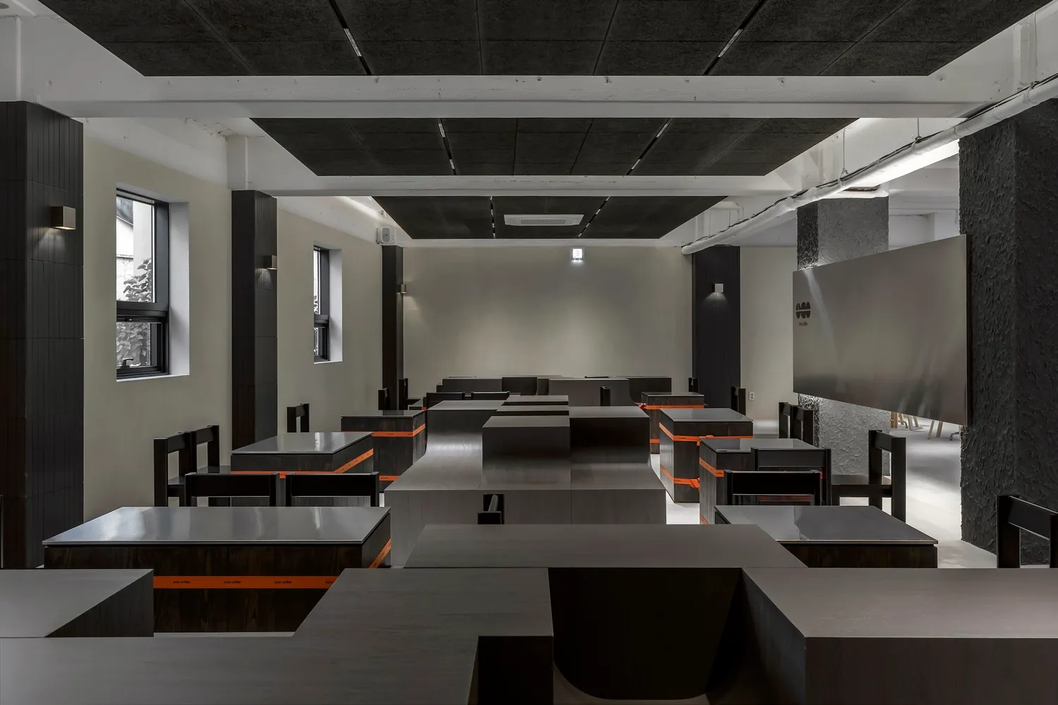 Industrial-style cafe interior with metallic black tables and chairs