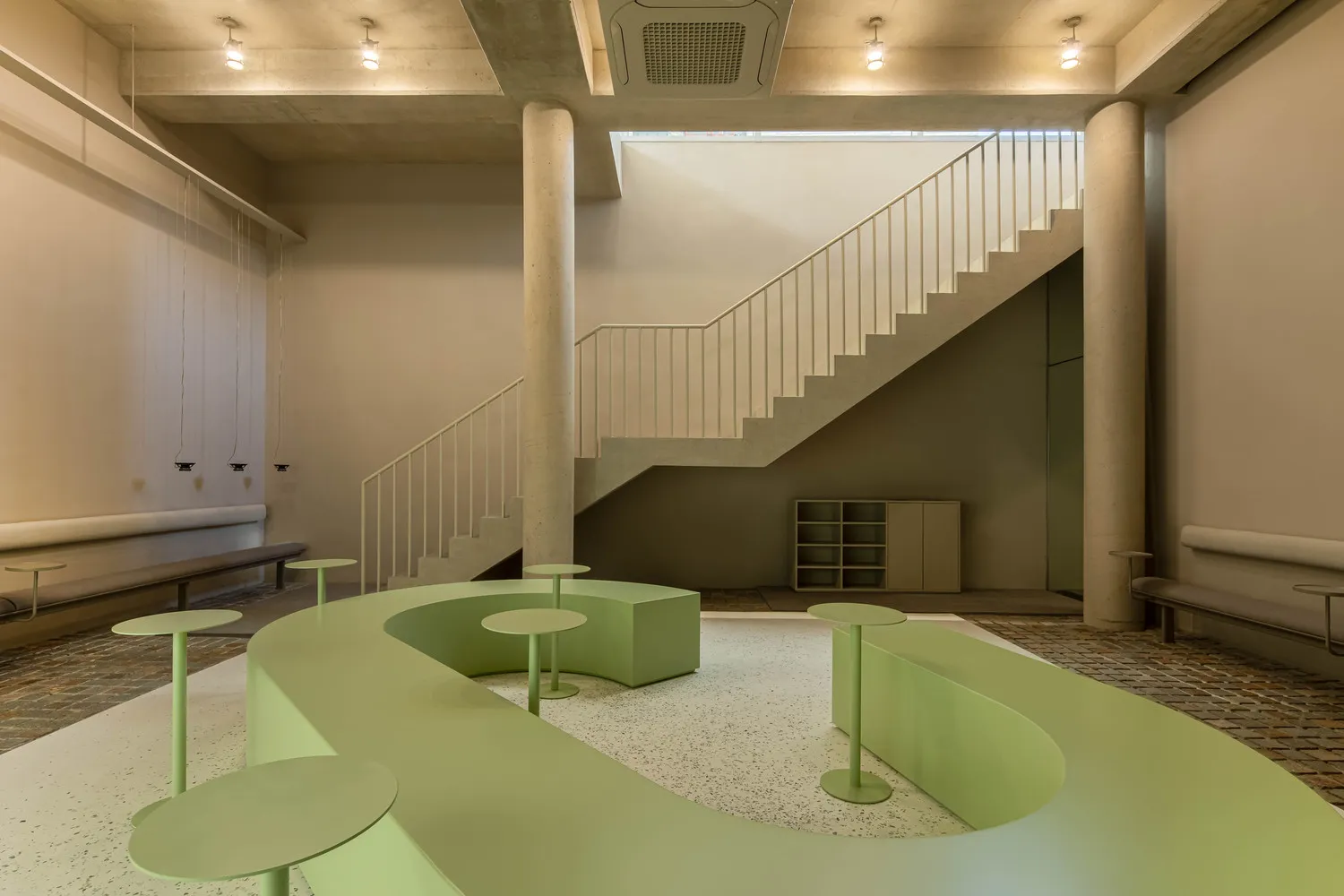 Industrial-style coffee shop interior with concrete and glass elements