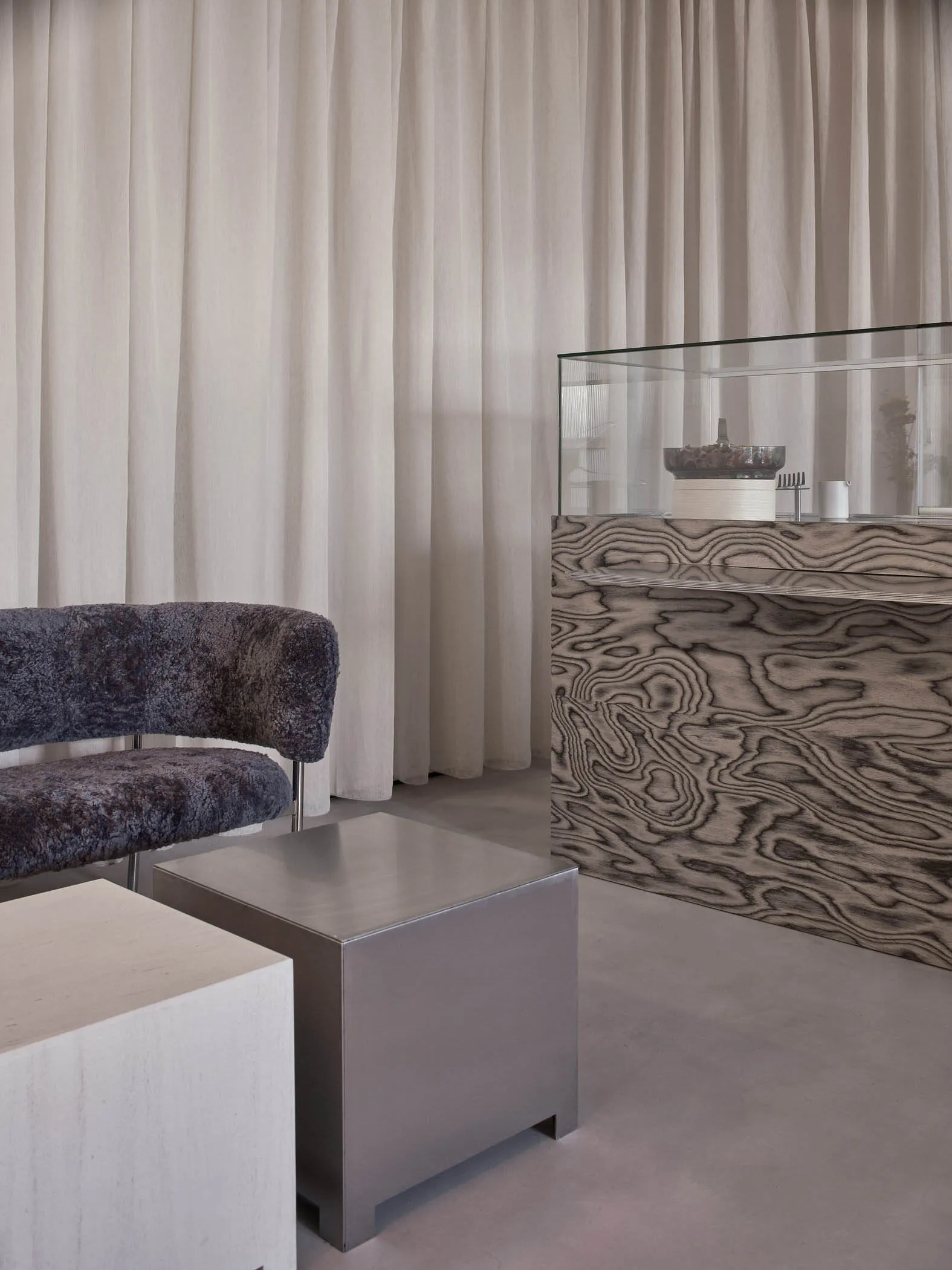 Modern office interior featuring minimalist design with metal and textile elements.
