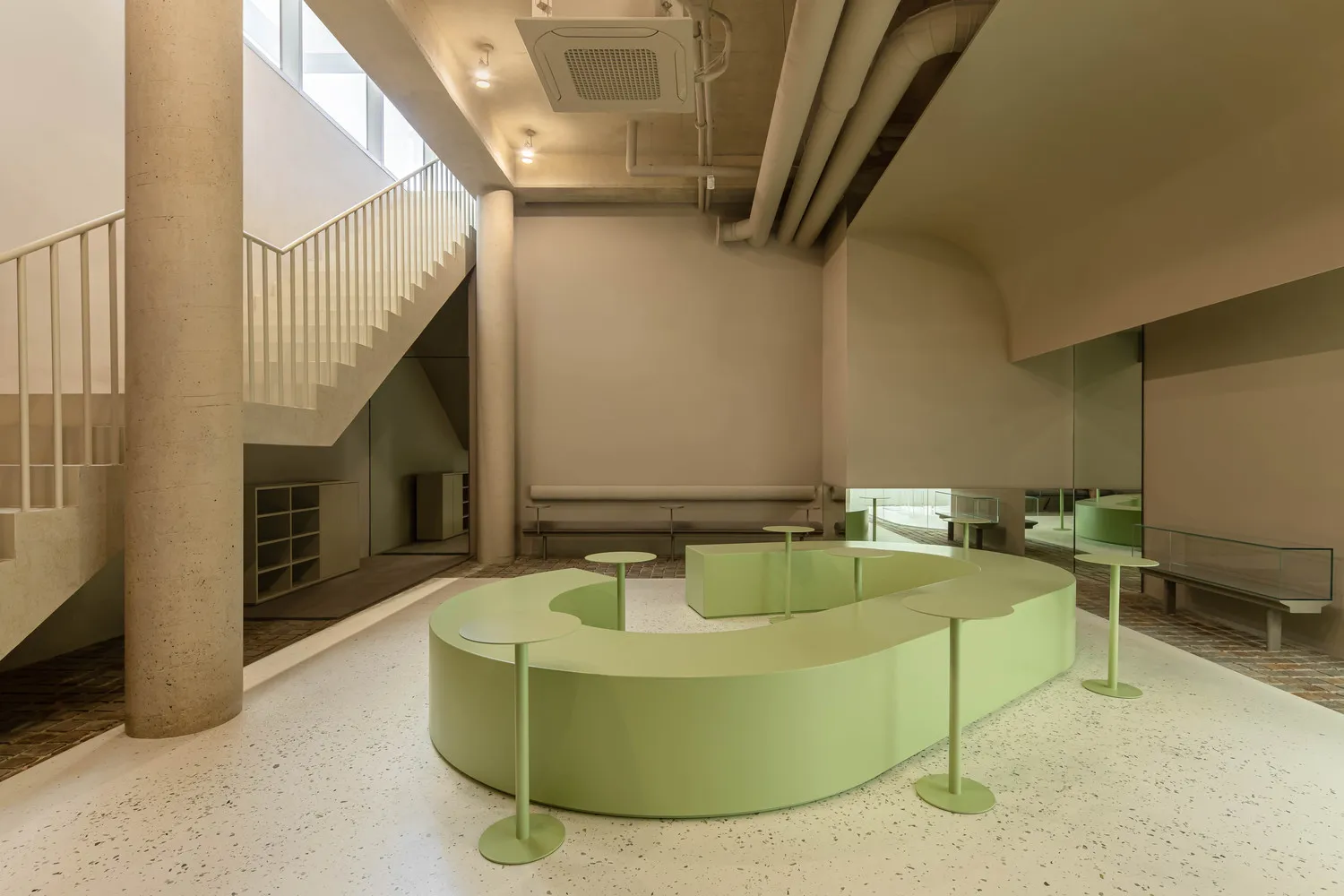 Modern office space featuring concrete walls and floors.