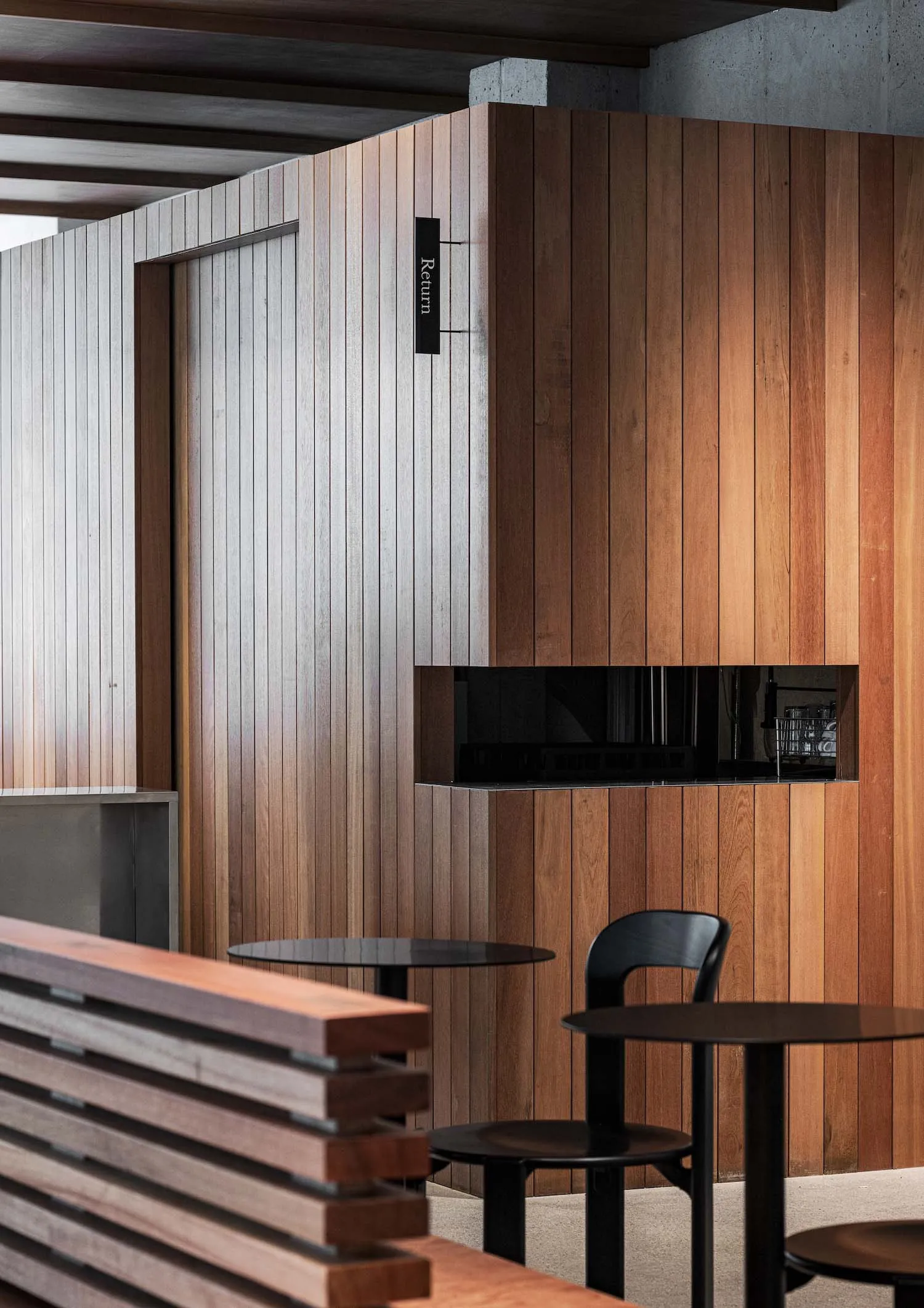 A modern coffee shop featuring wooden interior design elements
