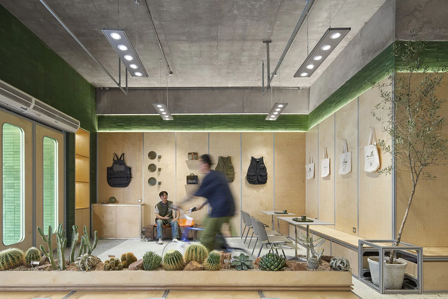 A modern industrial-style coffee shop with concrete, wood, and metal elements.
