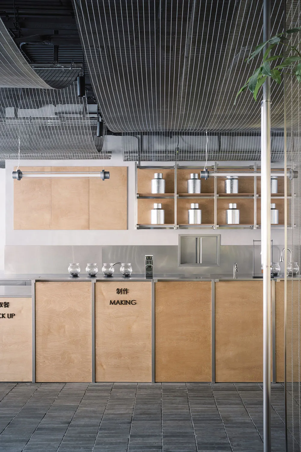Minimalist commercial kitchen with wood and stainless steel elements.