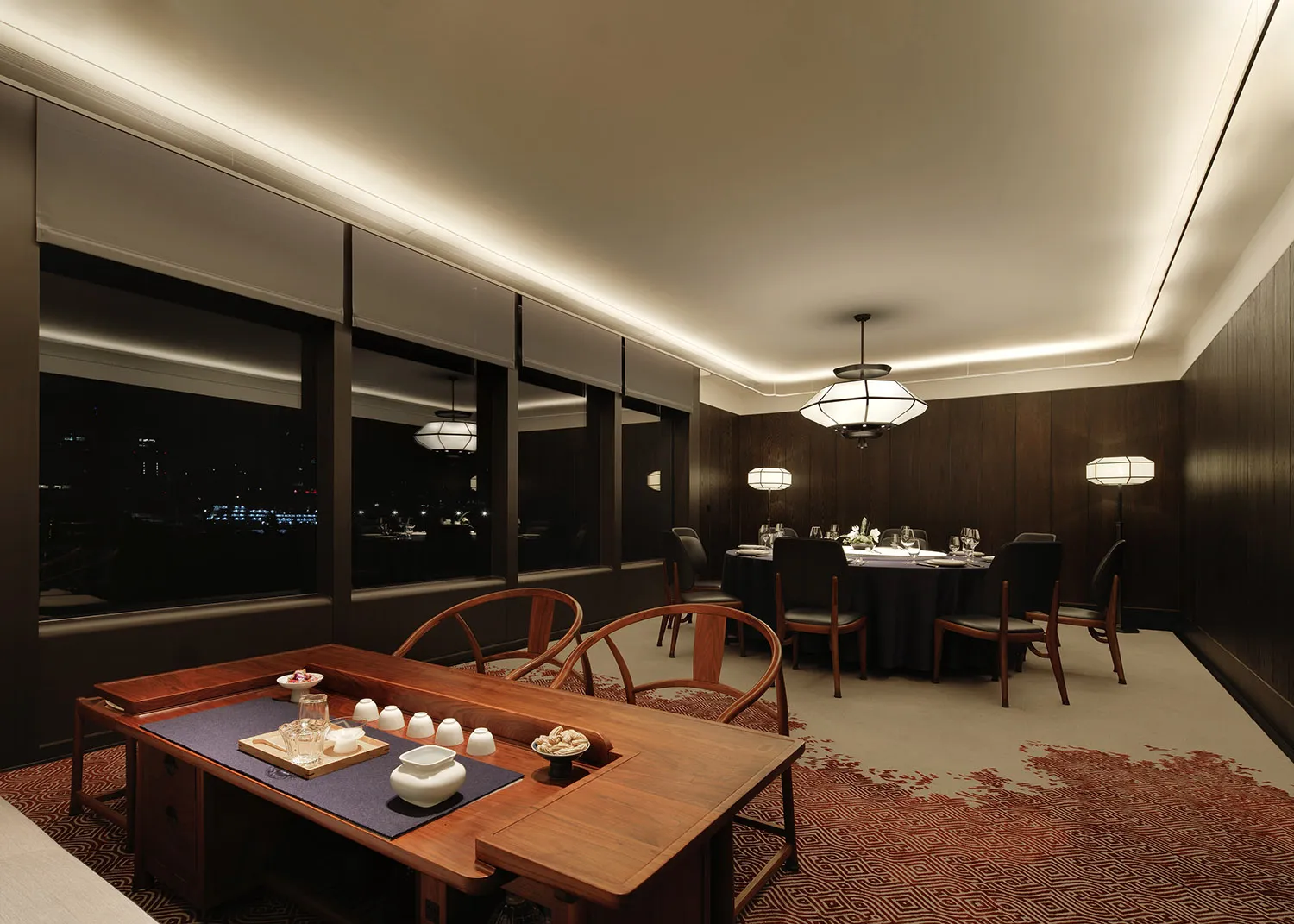 A well-lit, modern restaurant dining area featuring wooden furniture and a cozy atmosphere with large windows overlooking the
