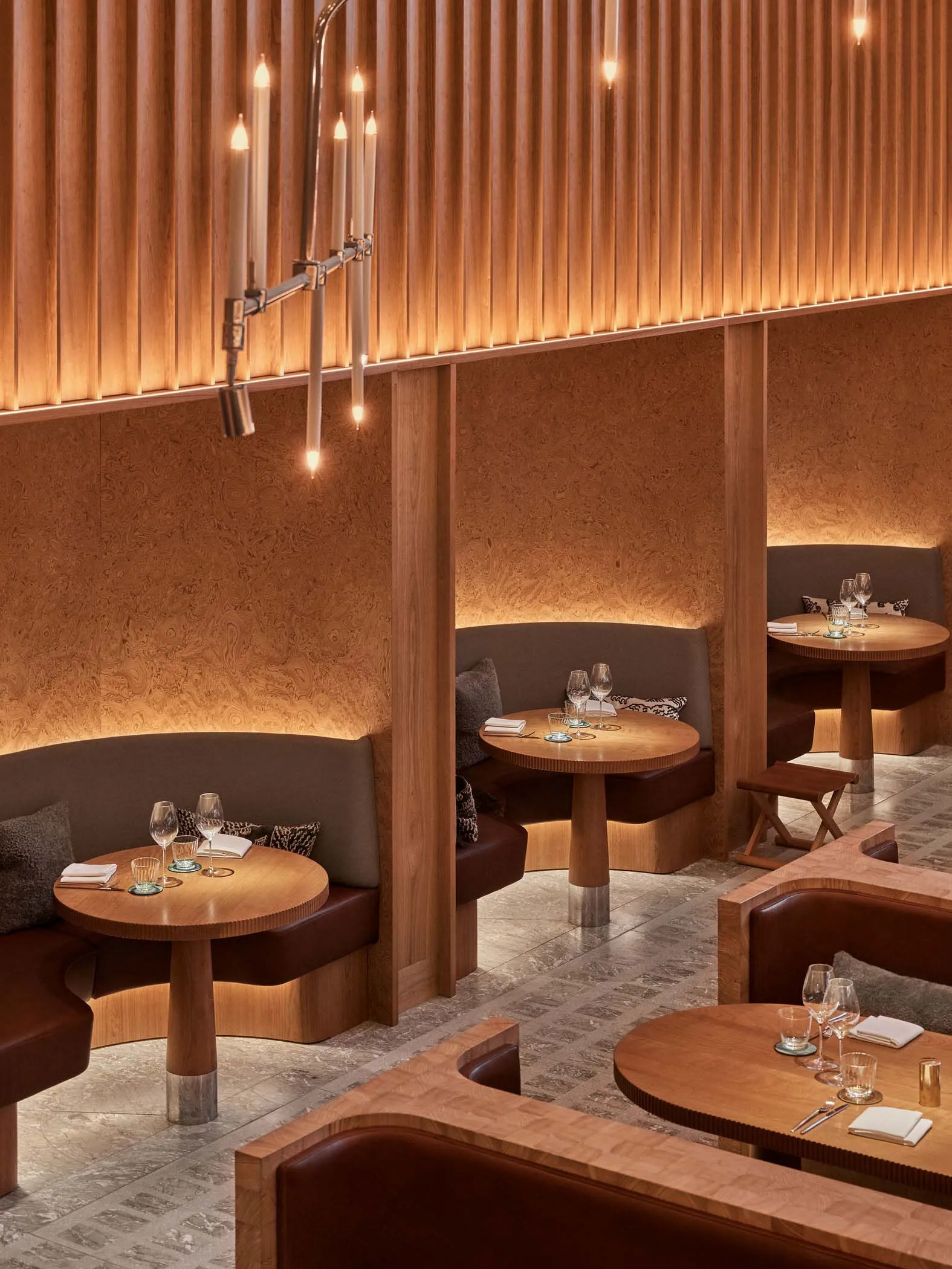 Warm timber restaurant seating with cozy booths and low lighting.