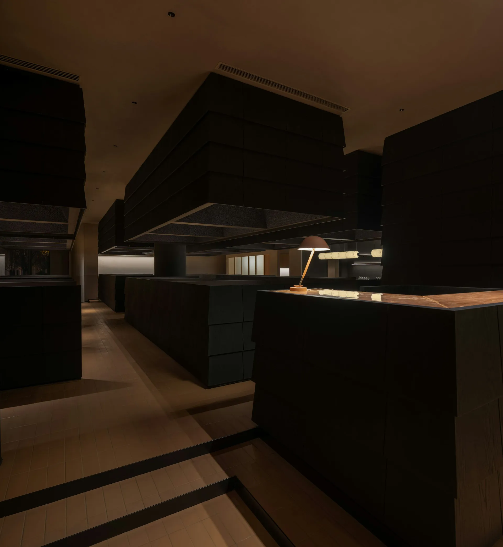 Modern restaurant interior with dark wood and concrete elements