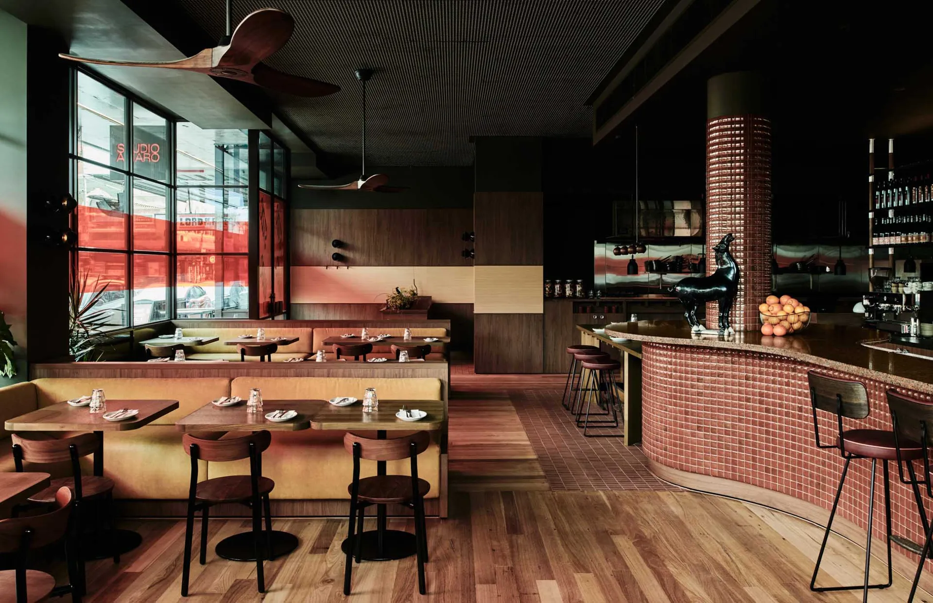 Modern restaurant with wooden tables and concrete walls