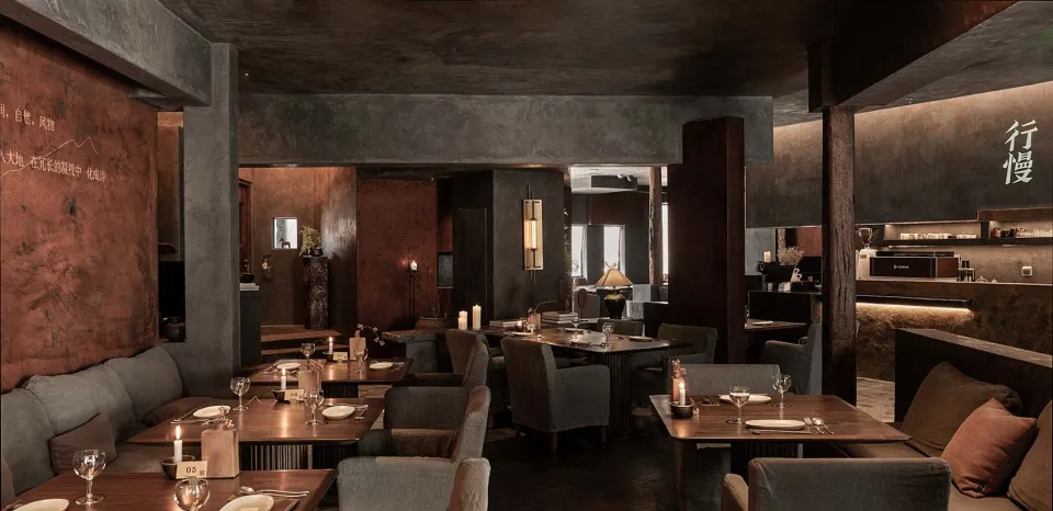 An industrial-themed restaurant with metallic walls, concrete floors, and loft-style design.