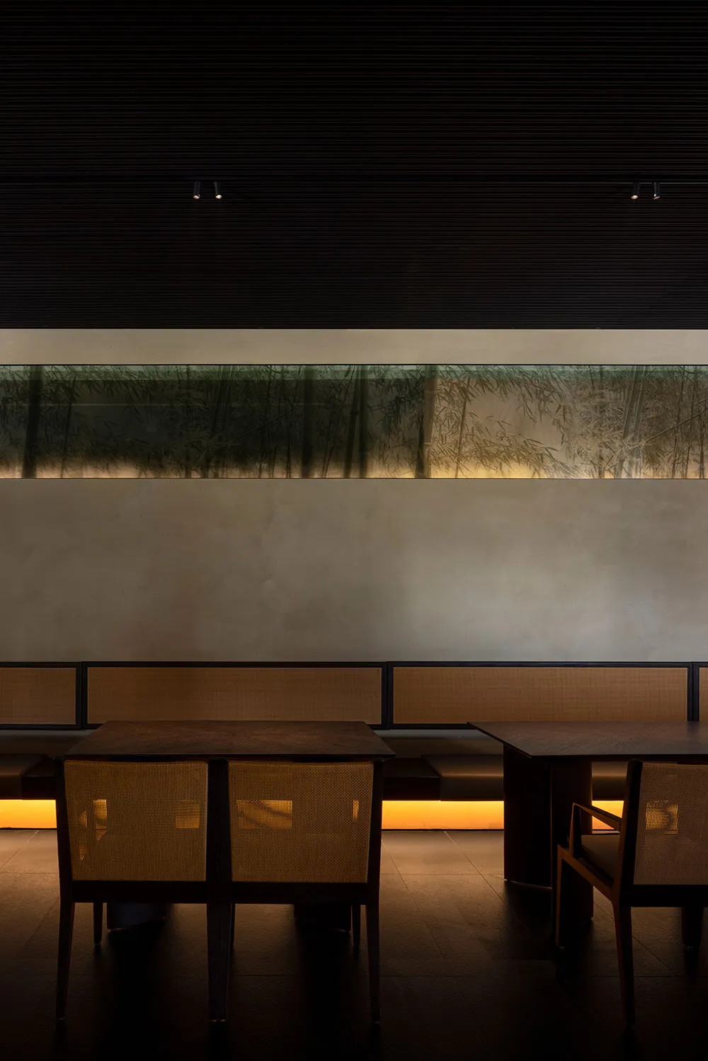 Modern cafe interior with wooden seating and lighting under the floor