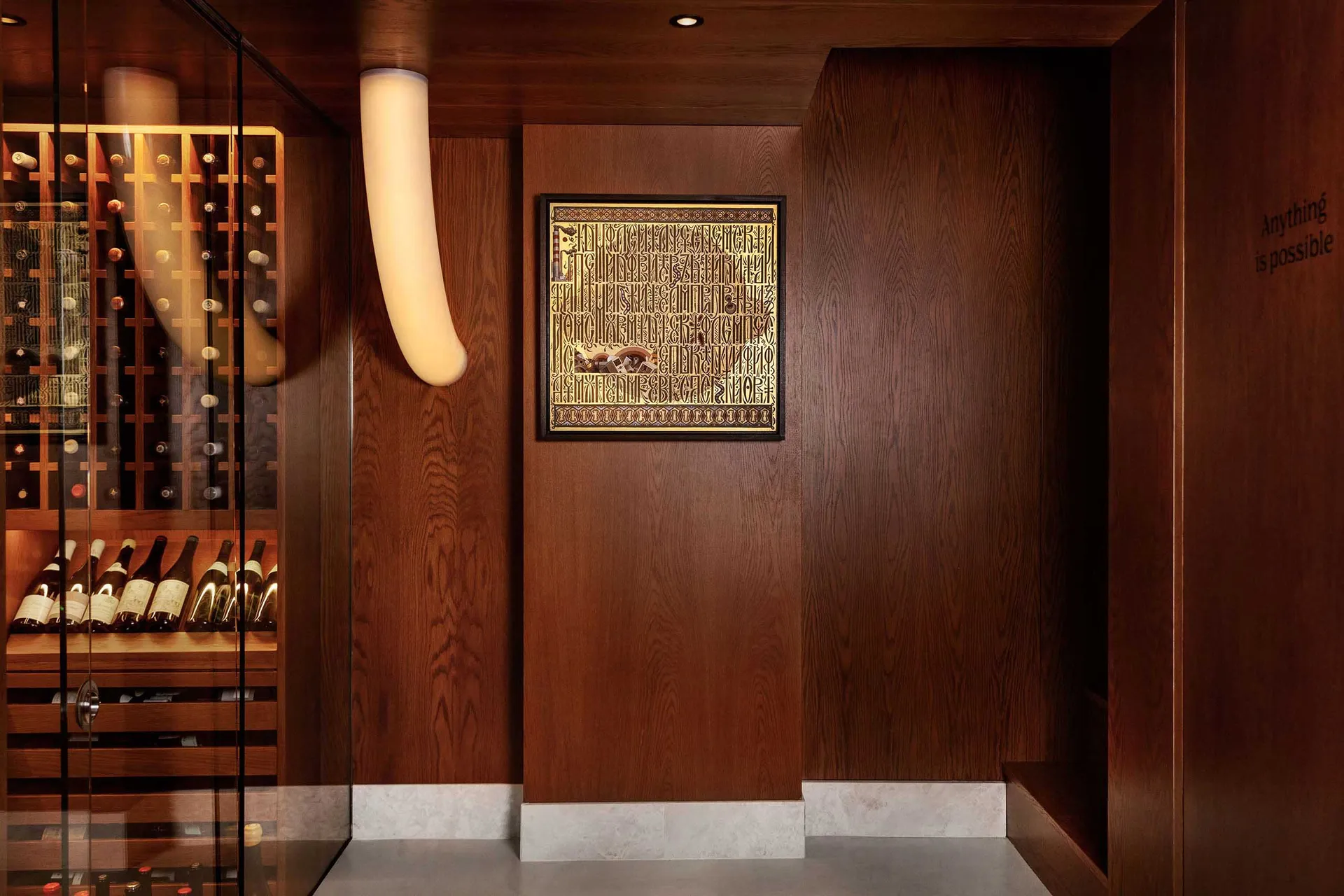 Modern interior design featuring a sleek, contemporary wine cellar with dark wooden panels, glass shelves, and a minimalist s