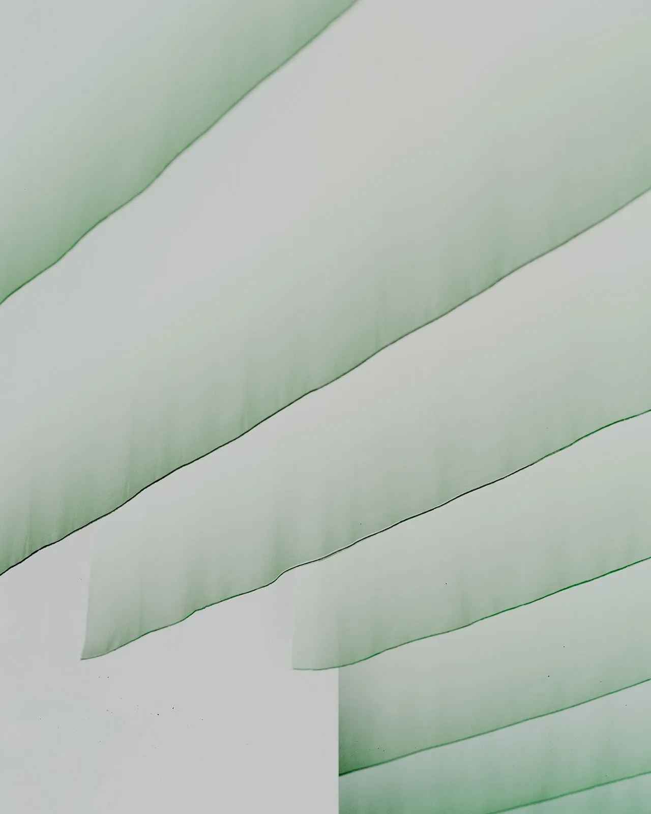 White interior with green curtains and drapes