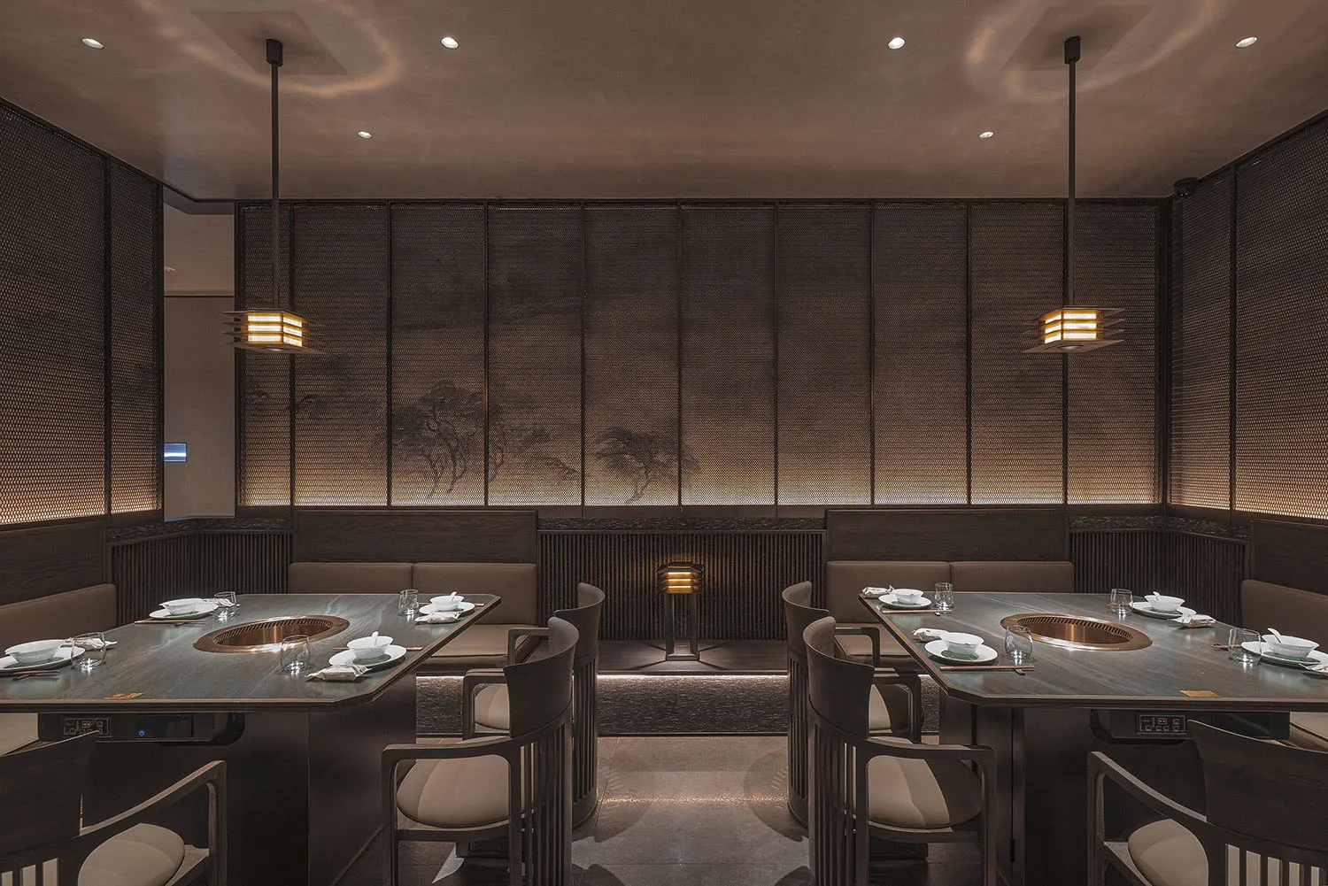 Modern restaurant interior with dark oak tables, white fabric seating, and minimalist lighting