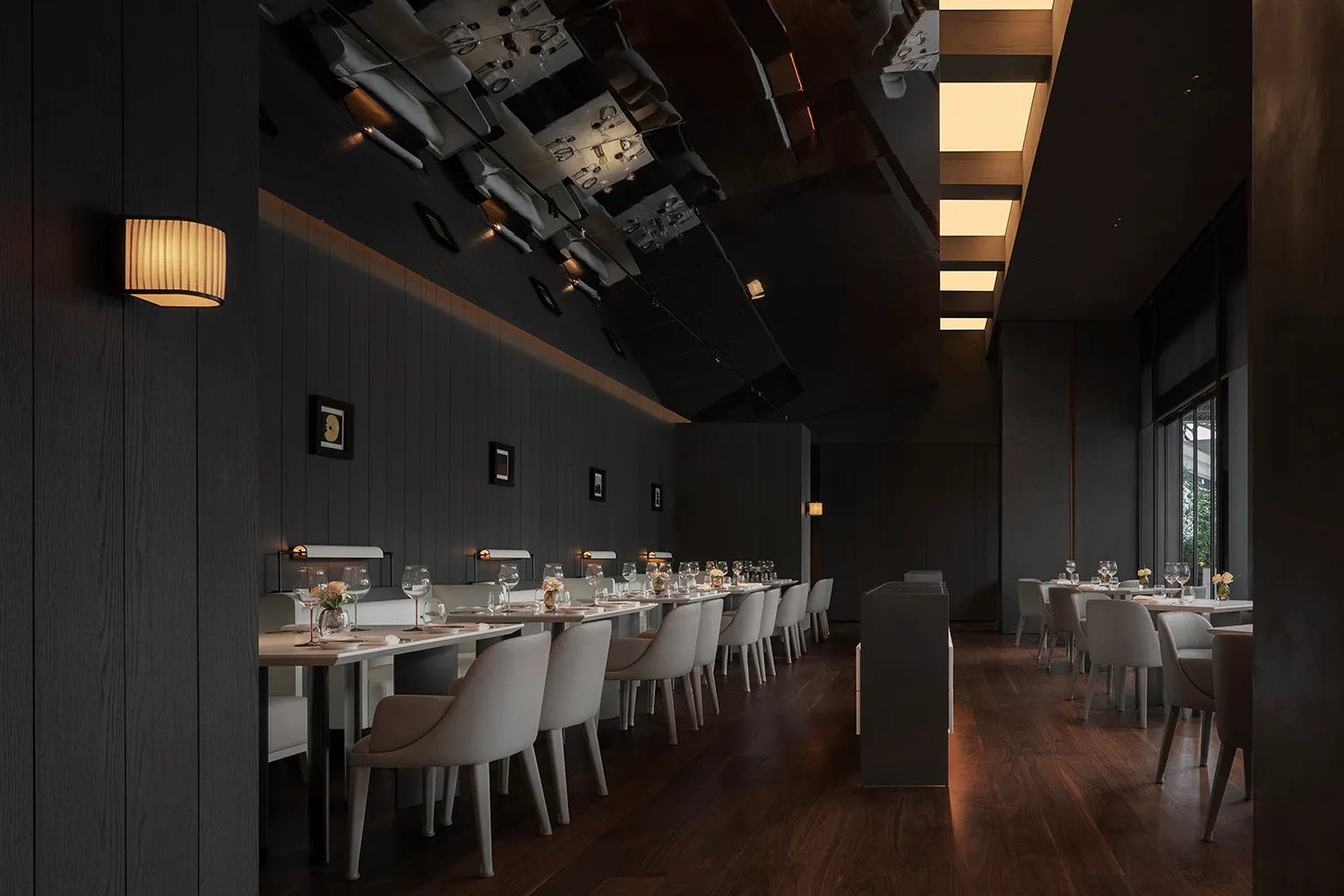The image depicts a modern restaurant interior featuring dark wooden elements, white furniture, and a minimalist design.