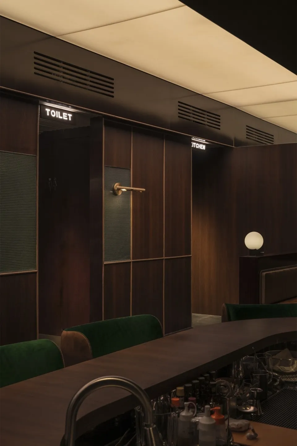 An industrial-style bar with a metal countertop and seating.