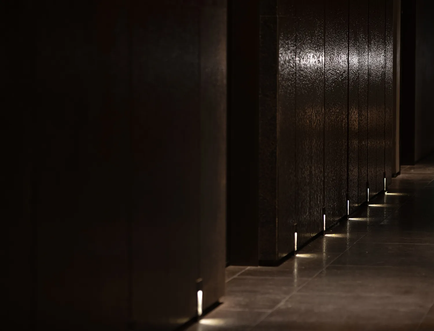 A minimalist hallway with a glass wall