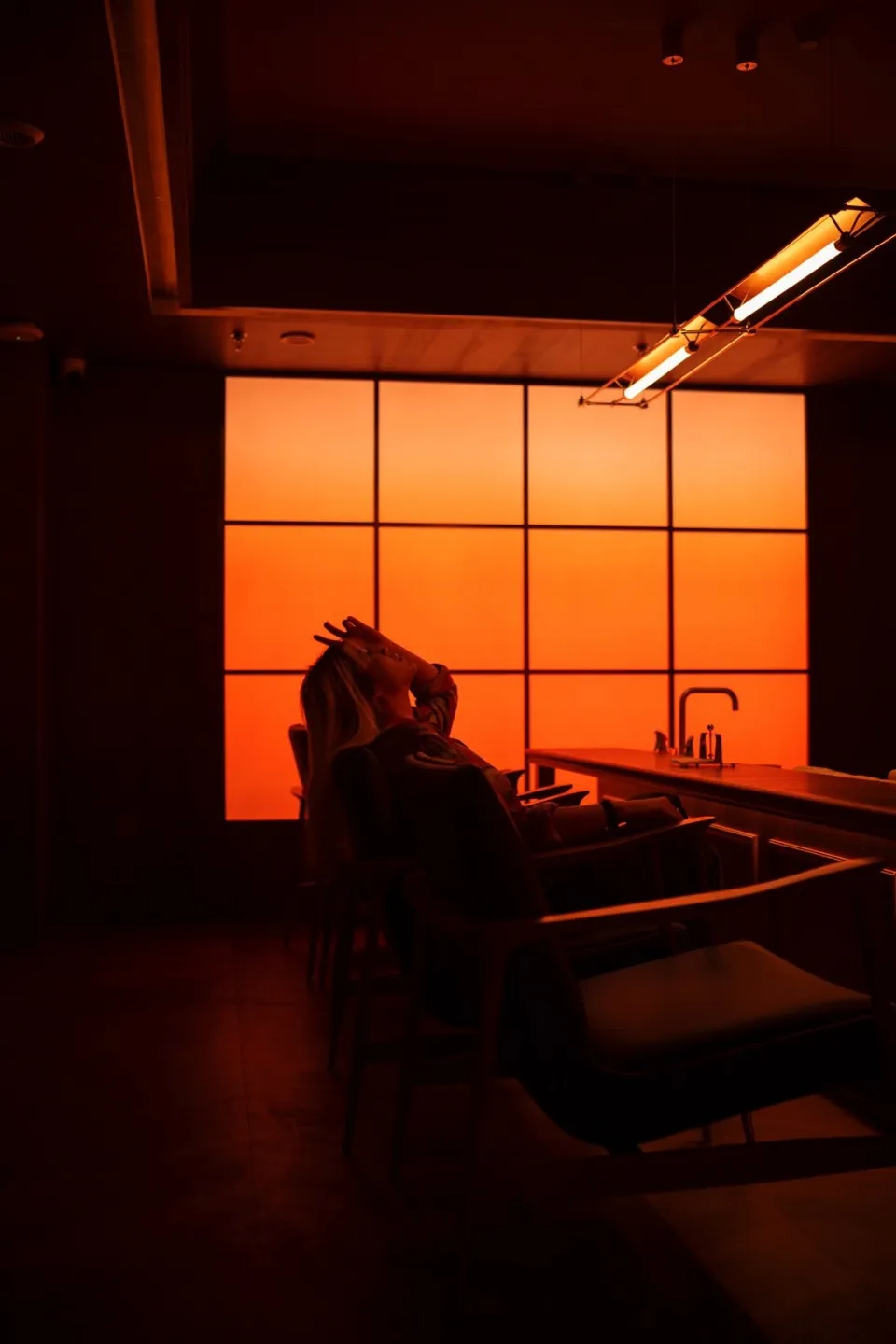 A faux marble restaurant interior with dim ambient lighting and modern seating arrangements.