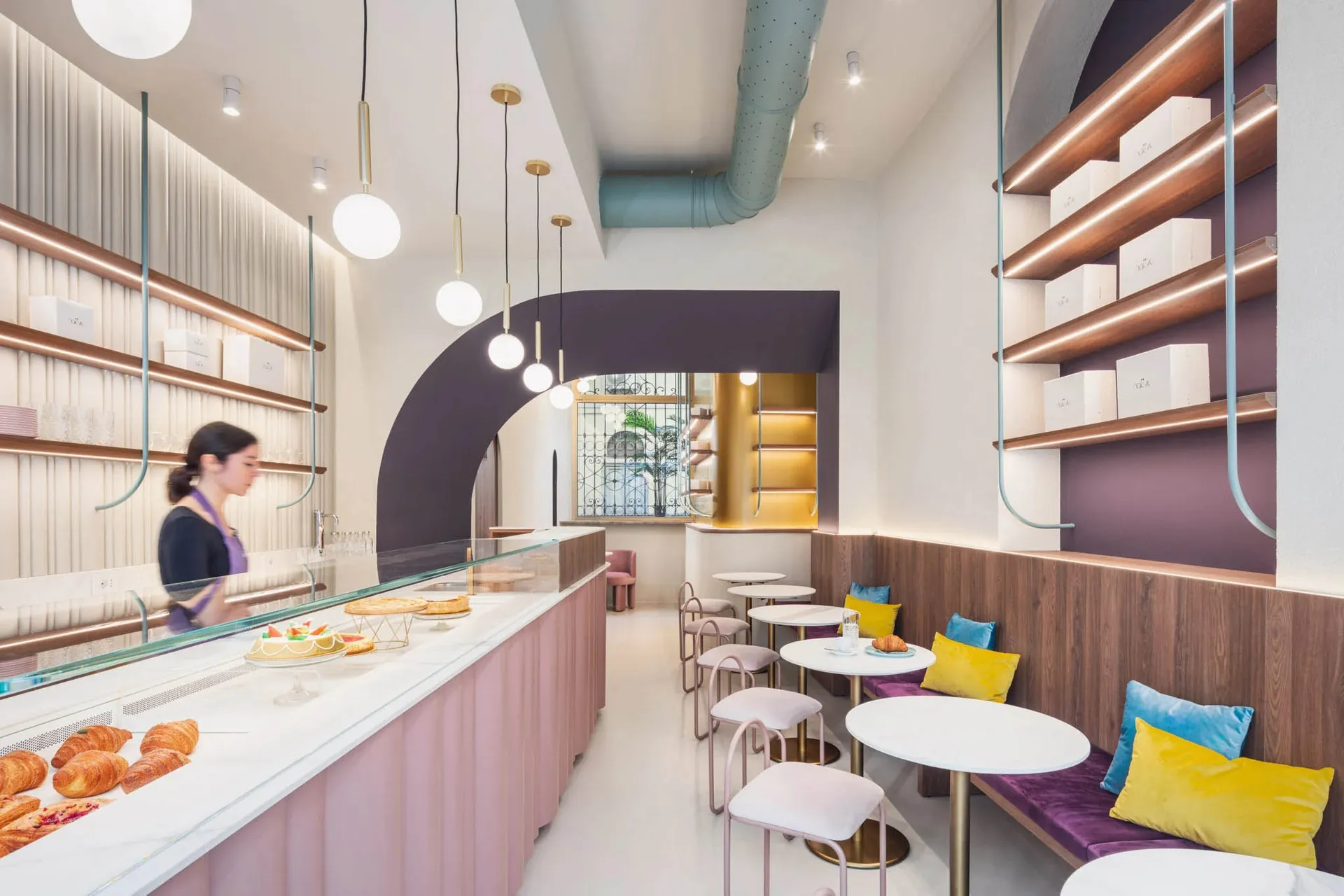 A modern industrial cafe with concrete, wooden, and metallic elements