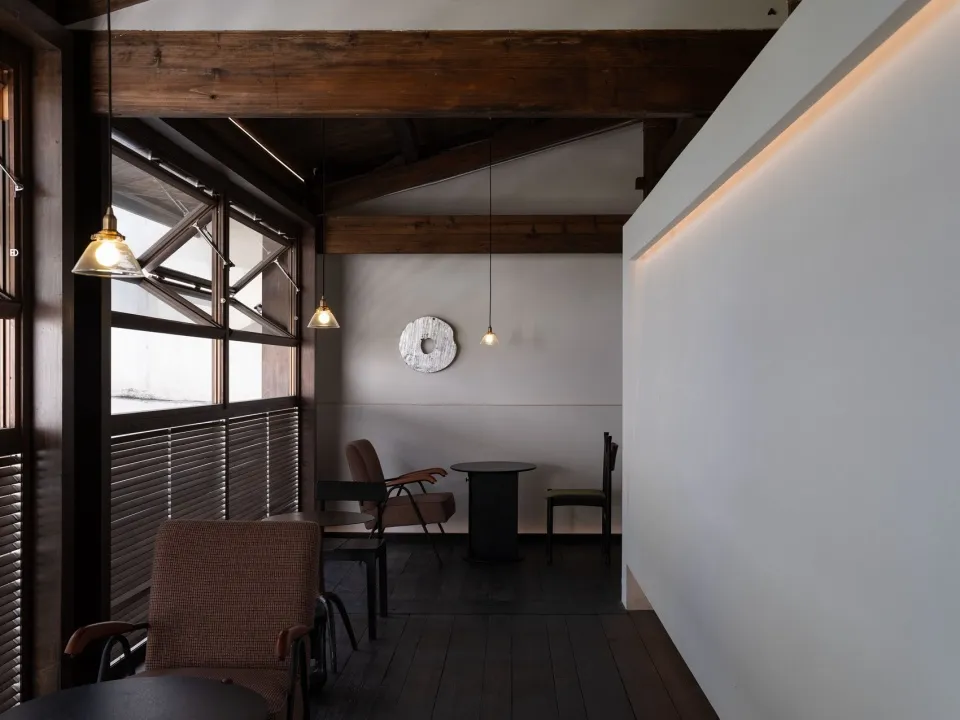 A modern coffee shop interior with wooden accents and minimalistic decor.