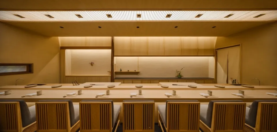 Modern restaurant interior with wooden furniture and minimalist design.