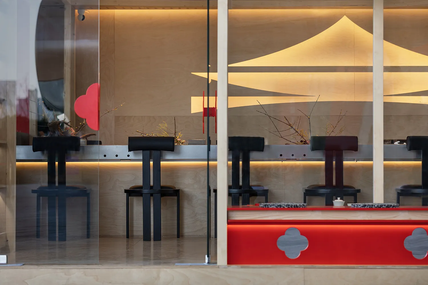 Interior of a minimalist restaurant featuring wooden elements and contemporary design.