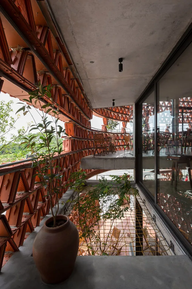 Modern terrace office with wooden payment counter and concrete ceiling.