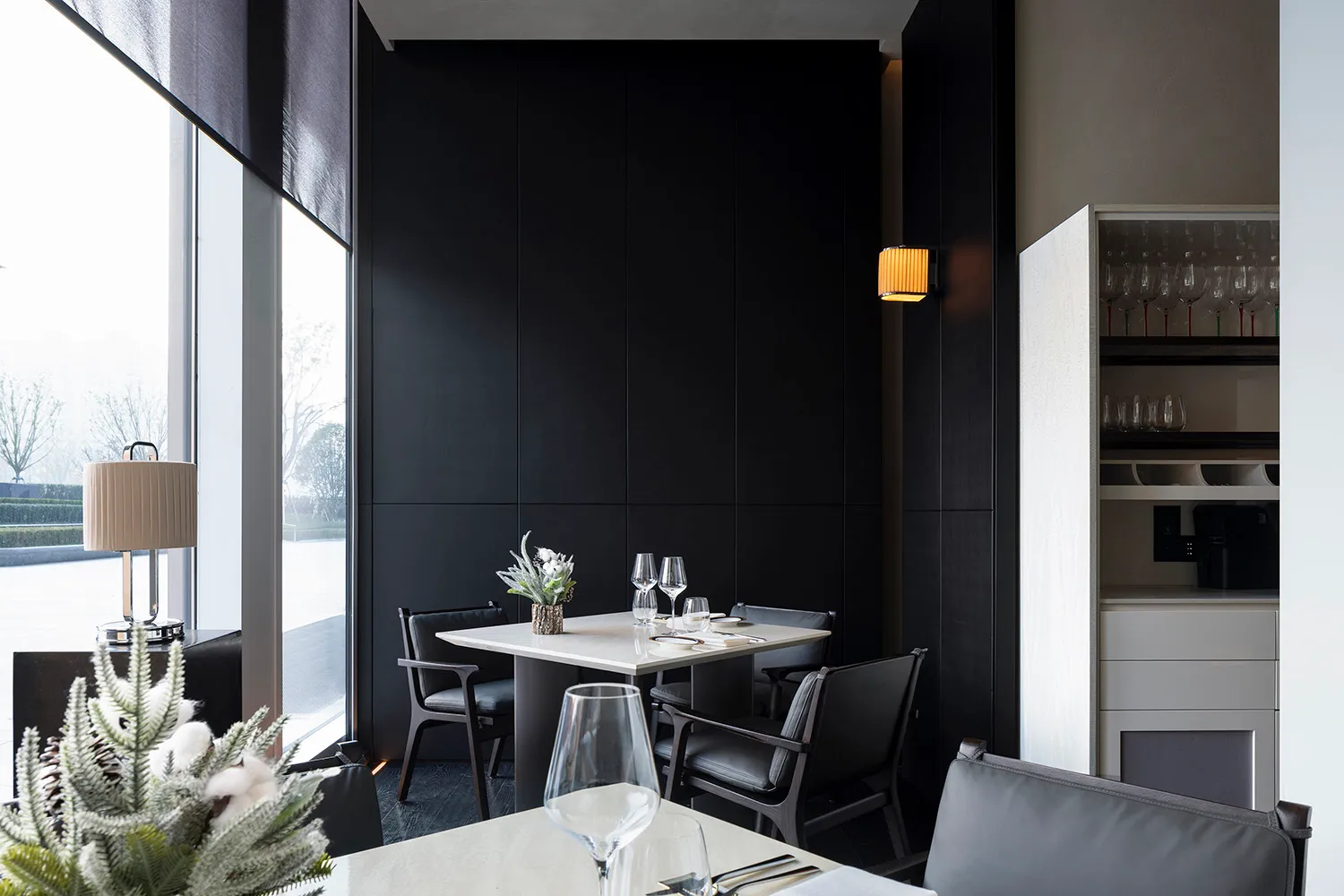 Modern minimalist restaurant interior with black and white color scheme, featuring contemporary furniture and sleek design el